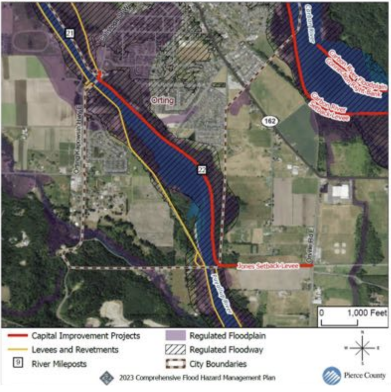 A satellite map shows a section of a river with fields and small towns on each side, with a red line marking improvement projects and a yellow lines marking levees.